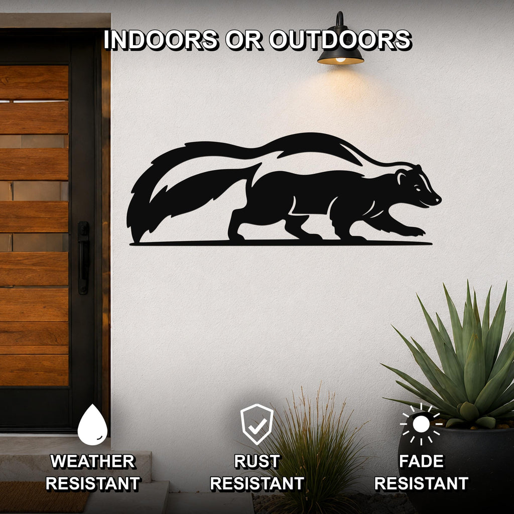 Black metal skunk wall art silhouette with a curved tail, mounted on a white exterior wall beside a wooden door and potted plants.