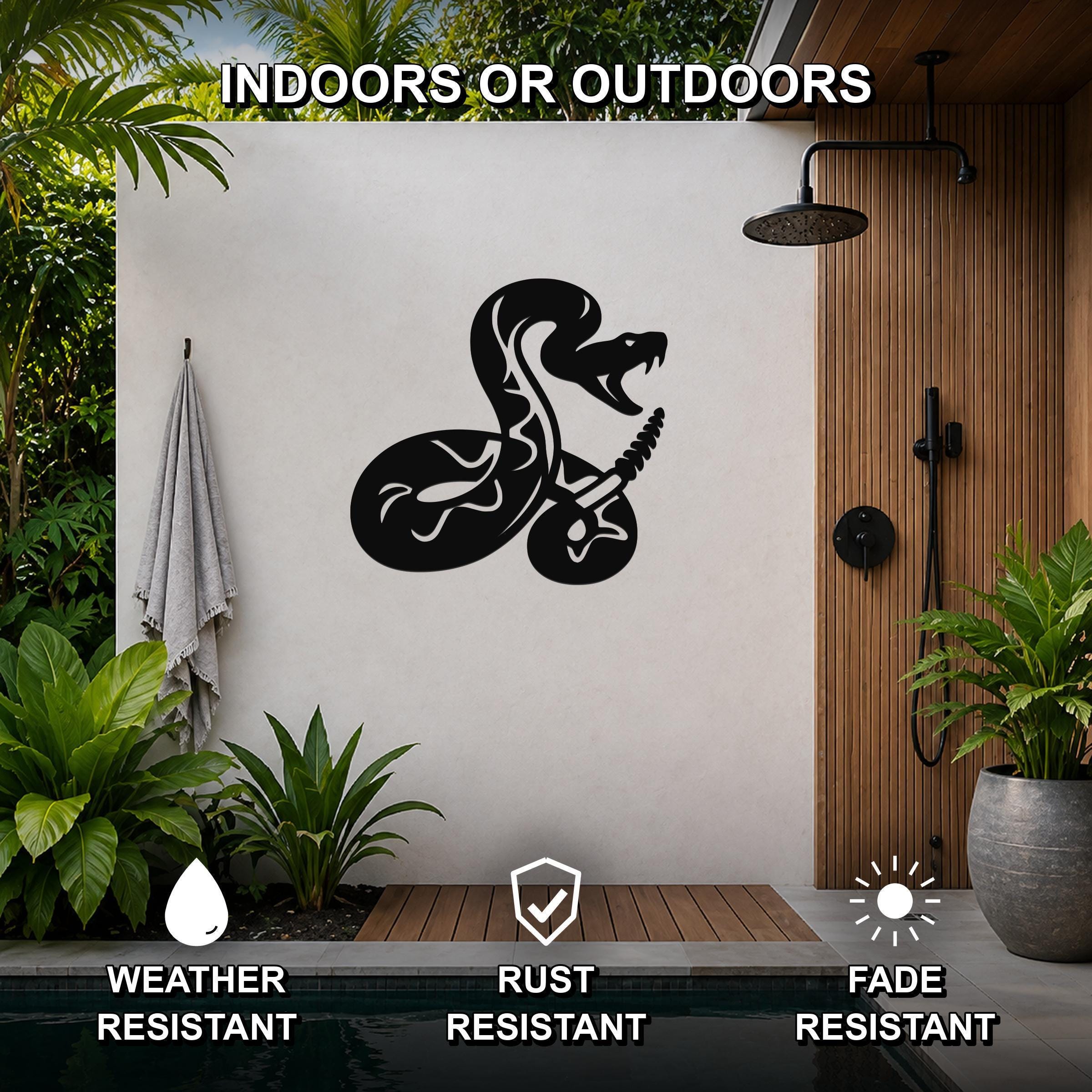 Black metal snake wall art with guitar cutout, mounted on a white outdoor wall beside a shower and pool.