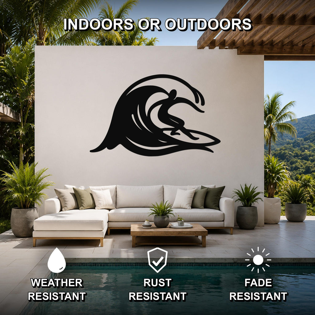 Black metal surfer wall art with a flowing wave silhouette, mounted on an outdoor patio wall above a white sofa near a pool.