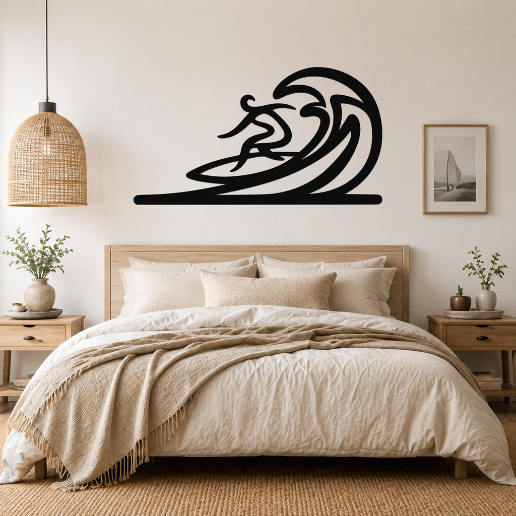 Black metal wall art in a silhouette of a surfer riding a wave, mounted above a bed in a bedroom.