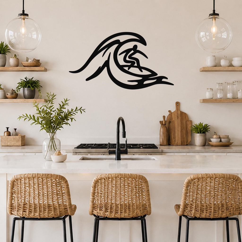 Black metal wall art cutout of a surfer riding a wave, mounted on a kitchen wall above a counter with wicker bar stools.