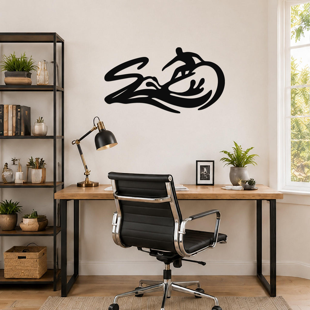 Black metal surfer wall art with wave and motion-line cutouts, mounted above a wooden desk in a home office.