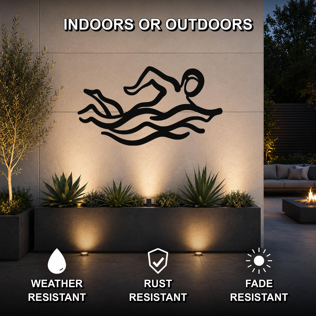 Black metal swimmer wall art with motion-line cutouts, mounted on an outdoor wall above a planter in a modern patio setting.