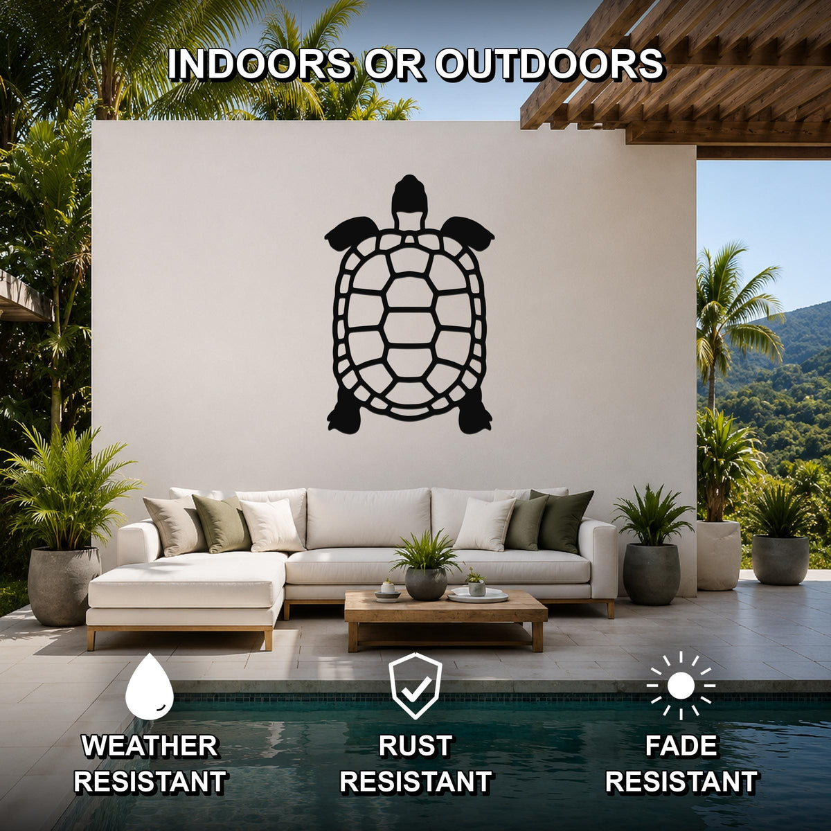 Black metal tortoise wall art with a cutout shell design, mounted on a white outdoor wall above a sofa in a patio living area.