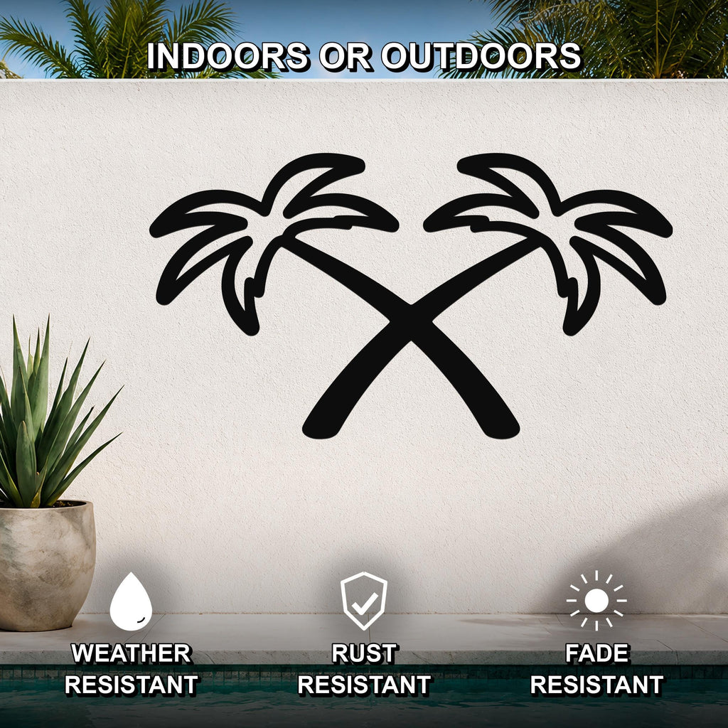 Black metal wall art featuring a silhouette of two crossed palm trees, mounted on an outdoor wall above a pool with a potted plant nearby.