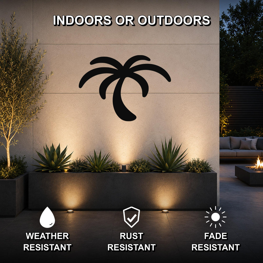 Black metal palm tree wall art with silhouette cutout, mounted on an outdoor wall above a planter in a modern patio setting.