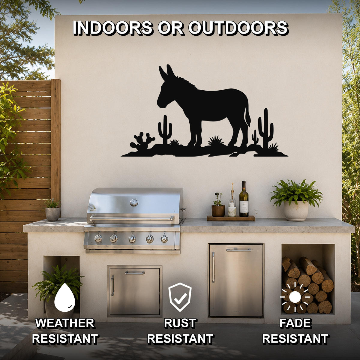 Black metal wall sculpture of a burro silhouette with cacti, mounted on an outdoor kitchen wall above a grill.