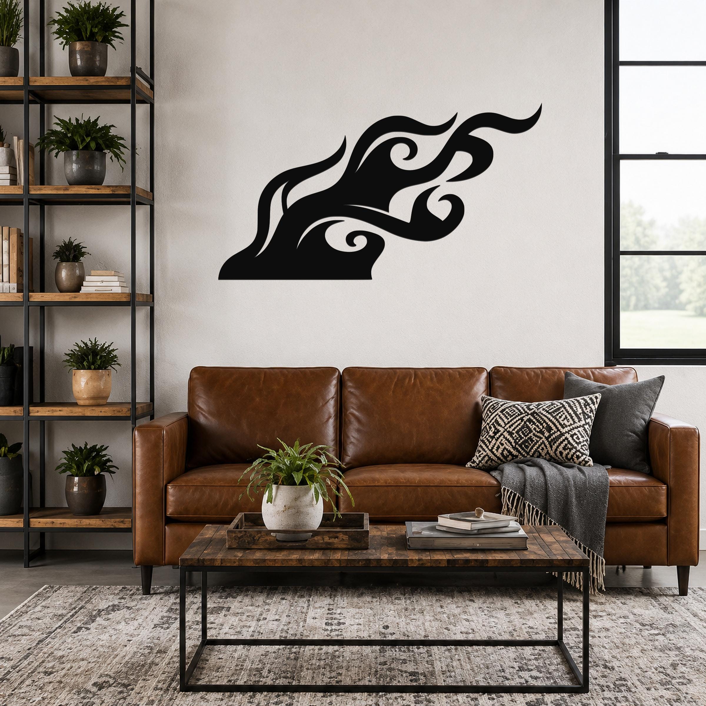 Black metal wall art with a bold, flowing flame silhouette, mounted above a brown leather sofa in a living room.