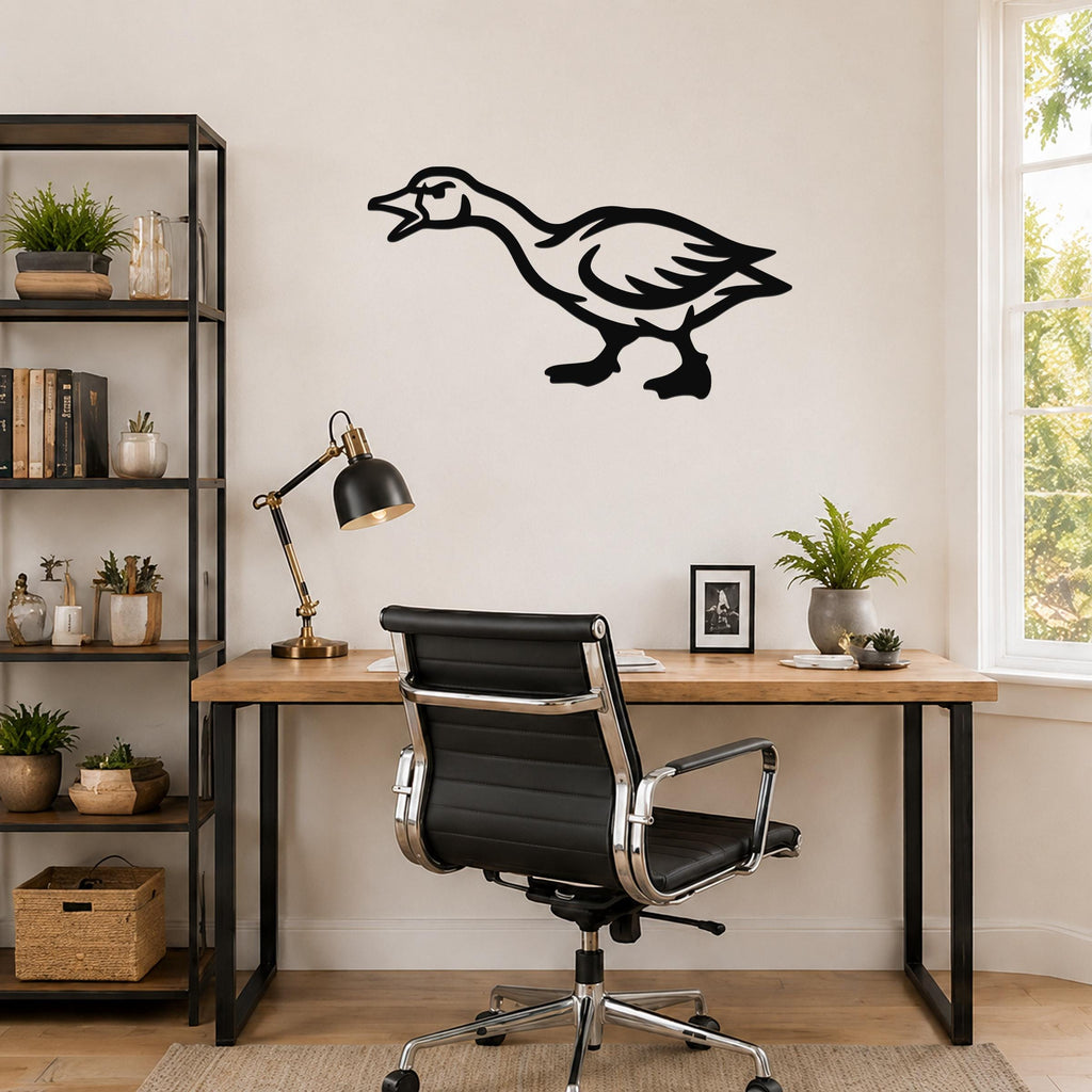 Black metal goose wall art with a bold silhouette design, mounted on a wall above a wooden desk in a home office.