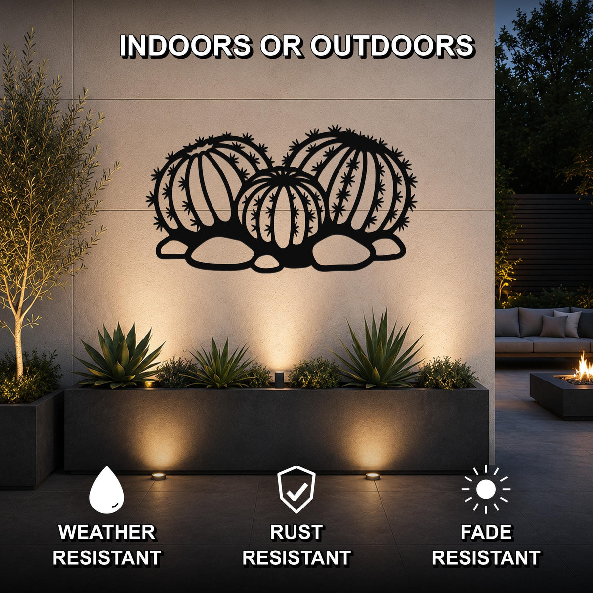 Black metal barrel cactus wall art with geometric cutouts, mounted on an outdoor wall above a planter in a modern patio setting.