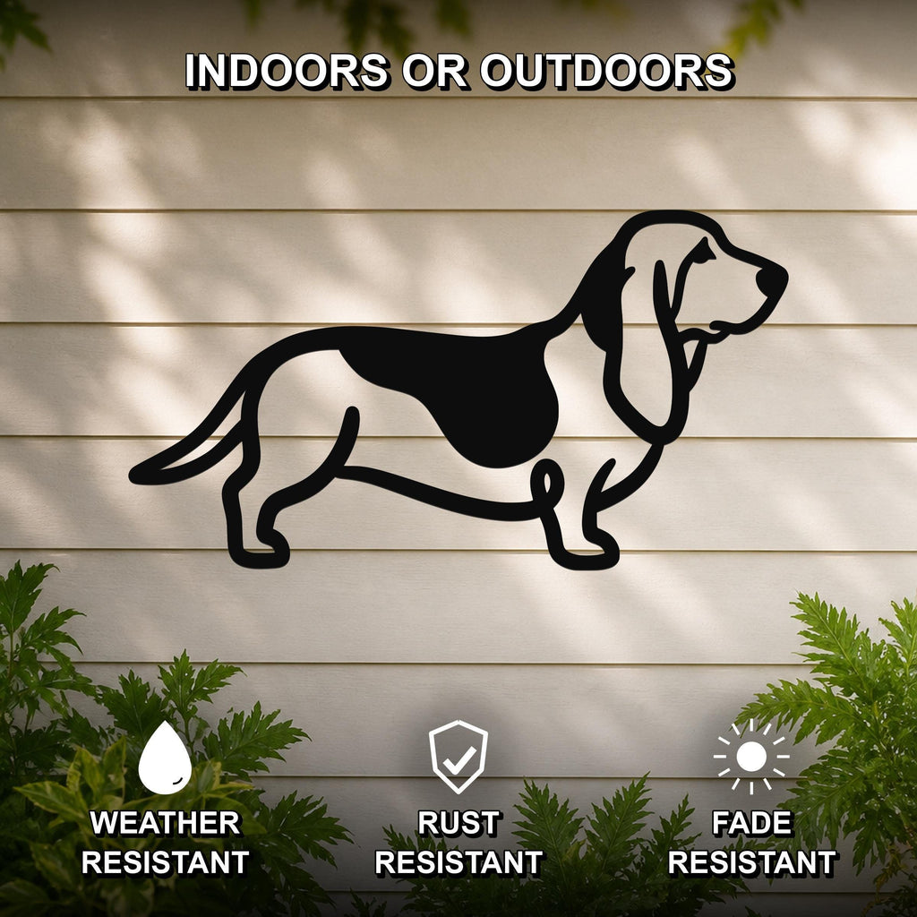 Black metal Basset Hound silhouette wall art mounted on a light-colored outdoor wall, with green plants at the base and text indicating it is weather, rust, and fade resistant.