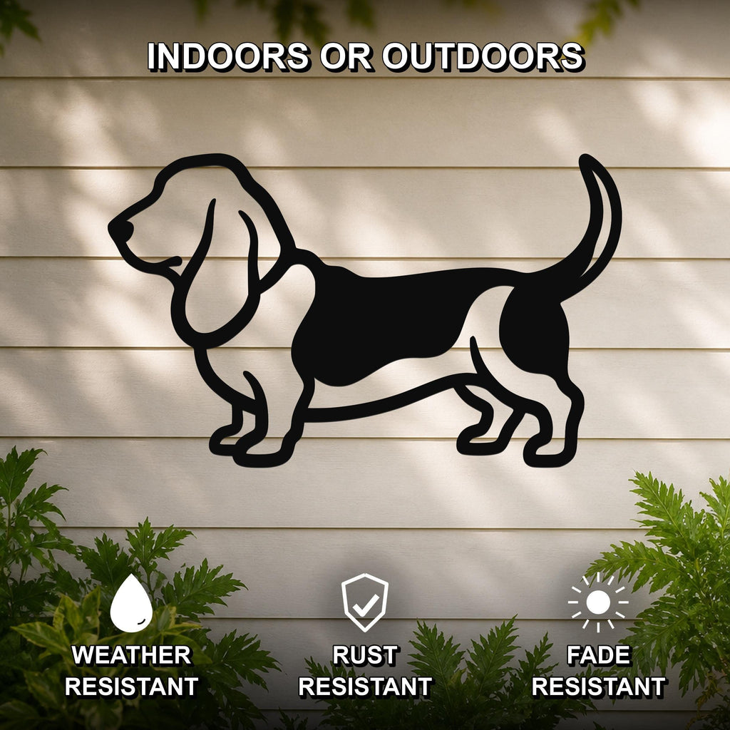 Black metal Basset Hound wall art silhouette mounted on a light-colored outdoor wall, with green plants at the base and text indicating it is weather, rust, and fade resistant.