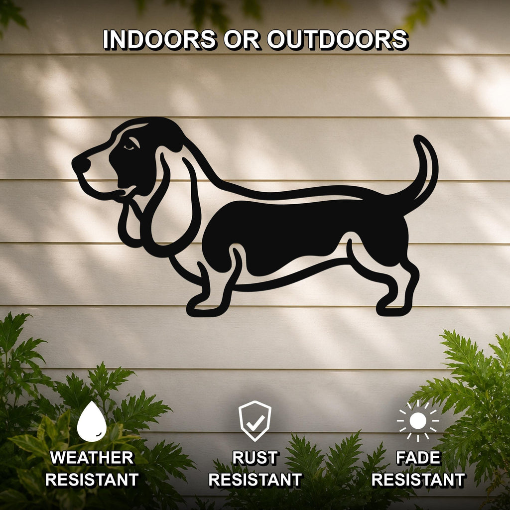 Black metal Basset Hound silhouette wall art mounted on a light-colored outdoor wall, with green plants at the base and text indicating it is weather, rust, and fade resistant.
