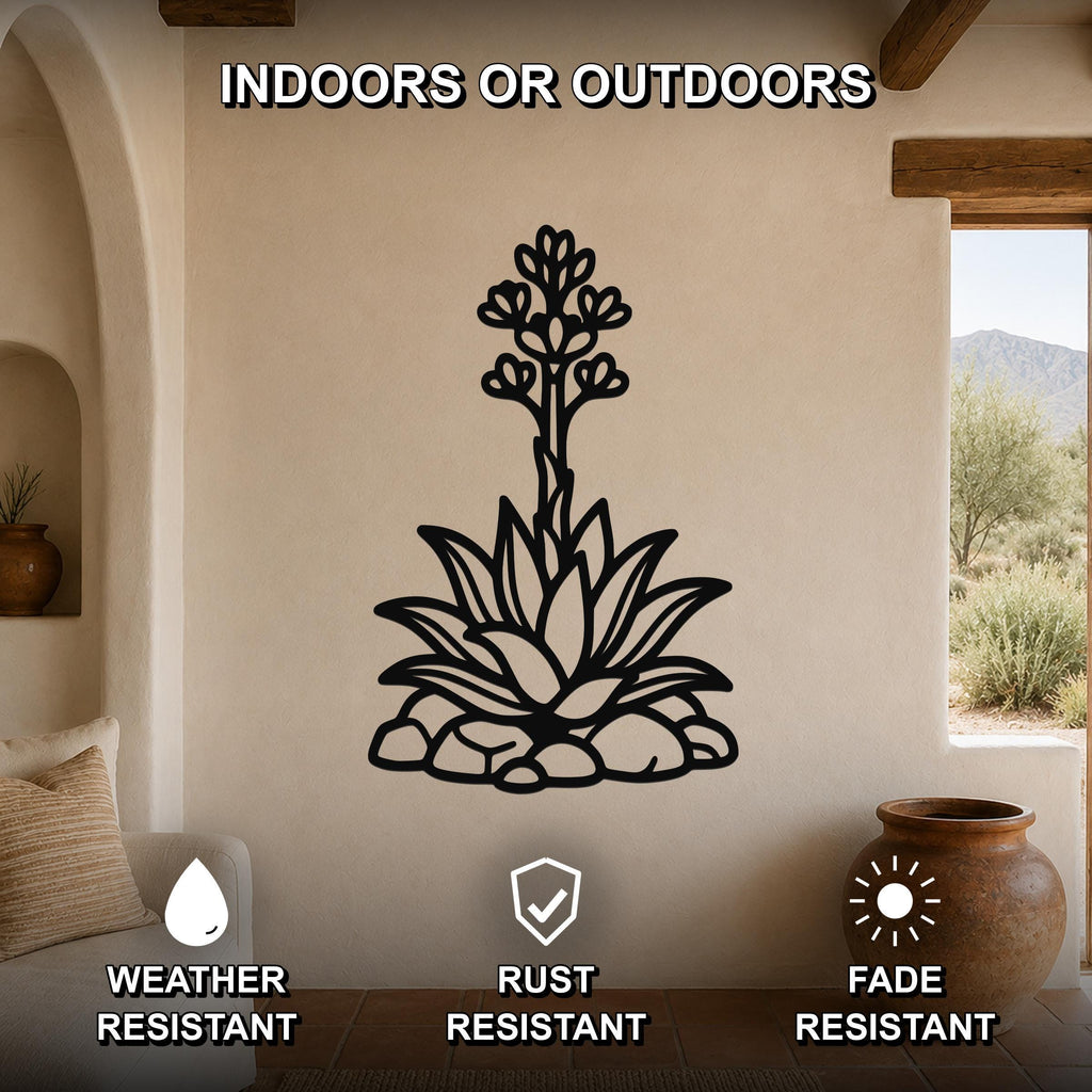 Black metal agave wall art with blooming flower and leaf cutouts, mounted on a beige living room wall above a sofa.