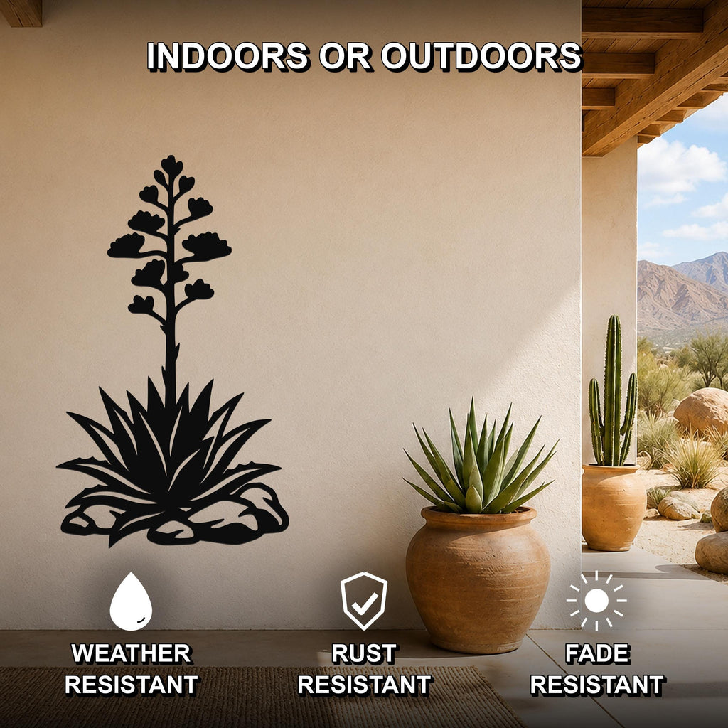 Black metal agave wall art with blooming flower cutout, mounted on a beige outdoor wall beside potted plants, weather and fade resistant.