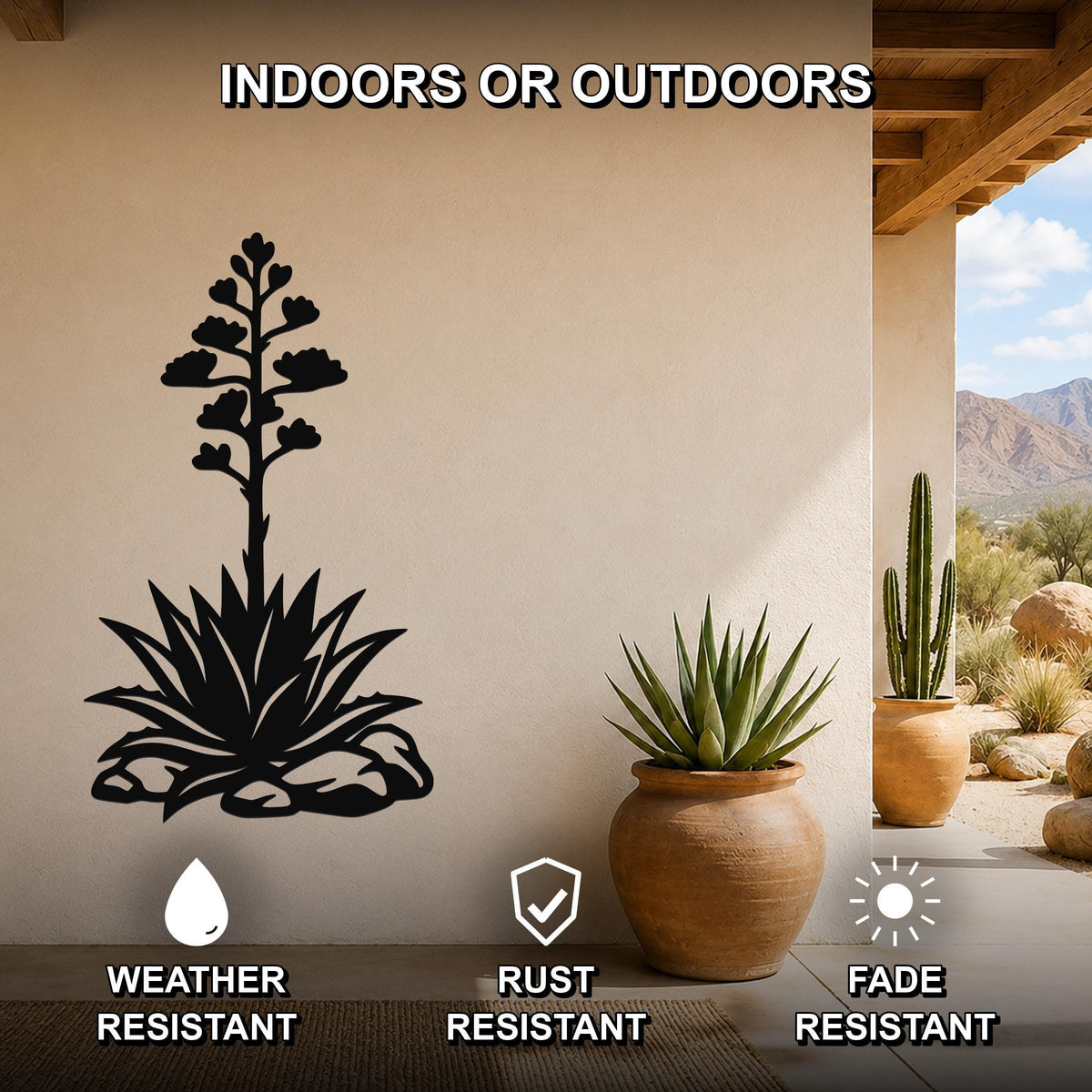 Black metal agave wall art with blooming flower cutout, mounted on a beige outdoor wall beside potted plants, weather and fade resistant.