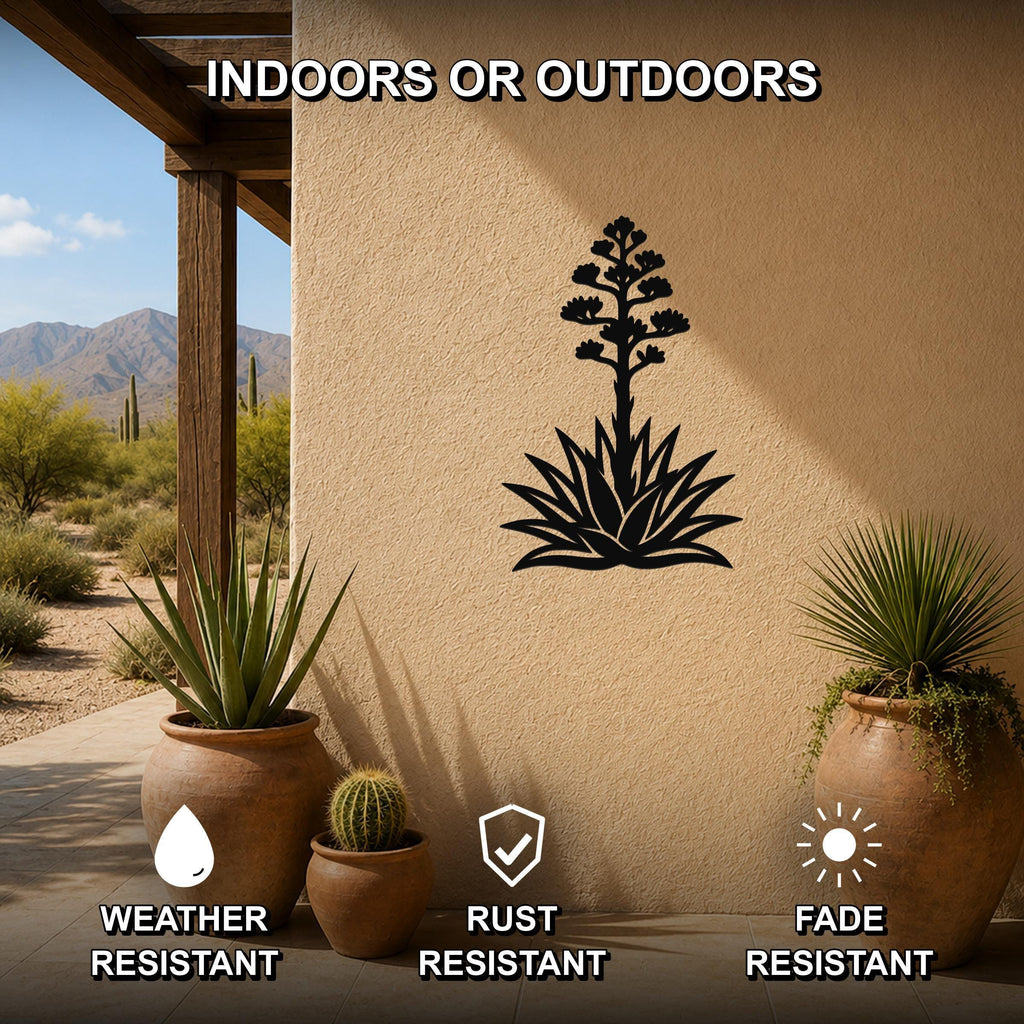 Black metal agave wall art with blooming flower cutout, mounted on a stucco outdoor wall above potted plants on a patio.