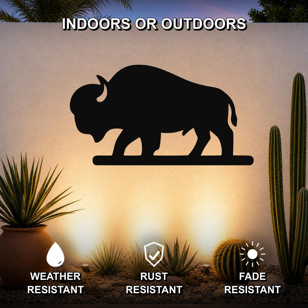 Black metal bison silhouette wall art mounted on an outdoor wall above a desert garden with cacti and succulents, featuring weather, rust, and fade resistance.