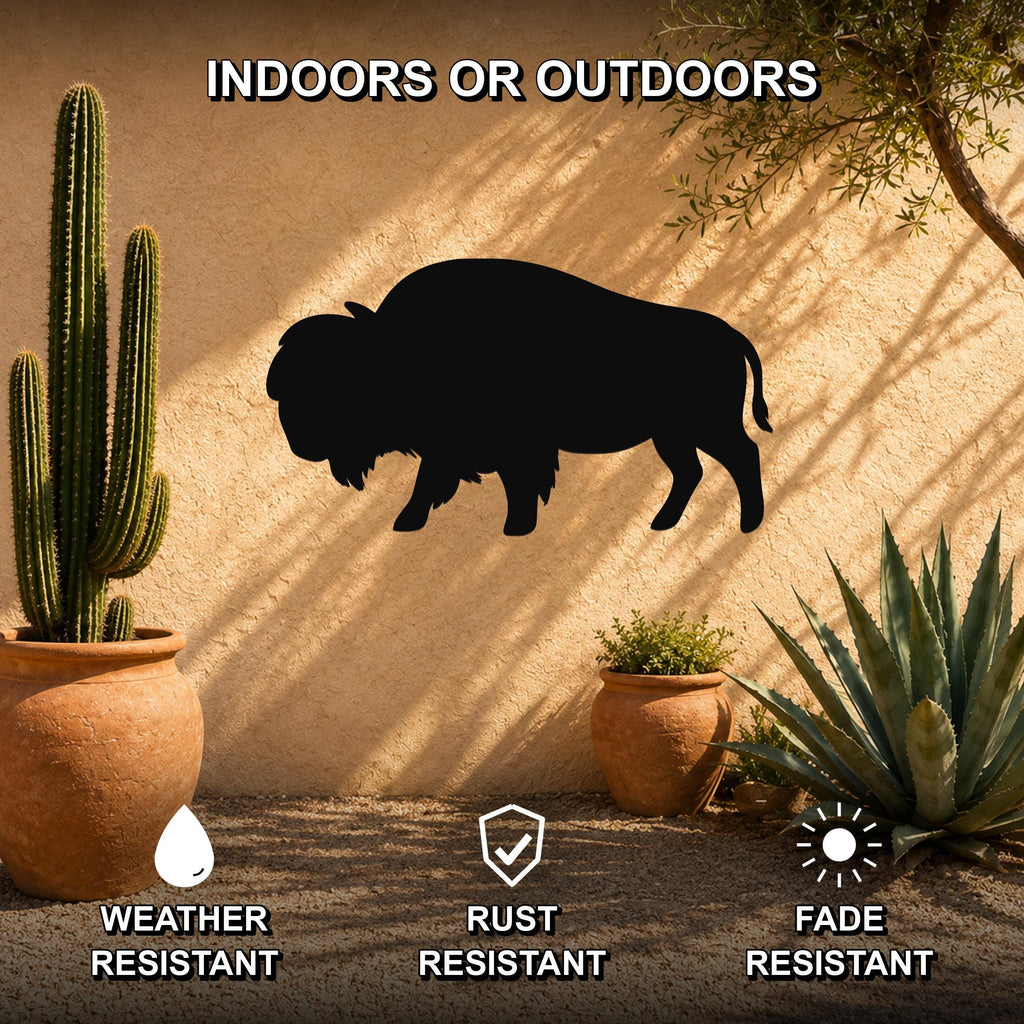 Black metal bison silhouette wall art mounted on a stucco outdoor wall, surrounded by potted cacti and succulents in a desert-style patio setting.
