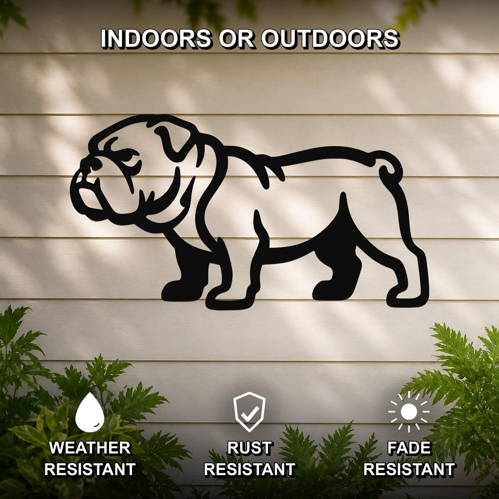 Black metal bulldog wall art silhouette mounted on a light-colored outdoor wall, with green plants at the base and text indicating it is weather, rust, and fade resistant.