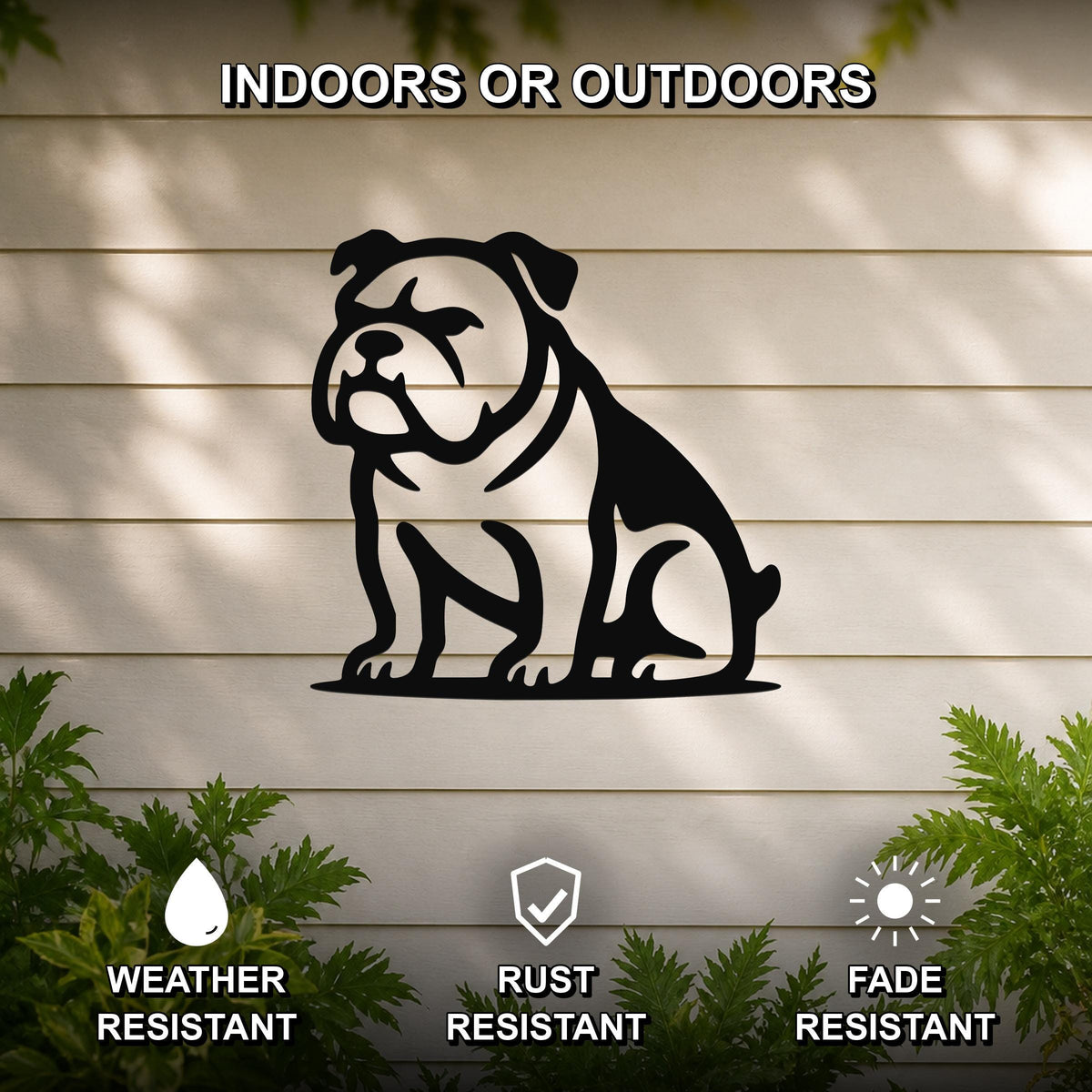 Black metal bulldog wall art with a bold silhouette, mounted on a light-colored outdoor wall with greenery, weather resistant, rust resistant, and fade resistant.