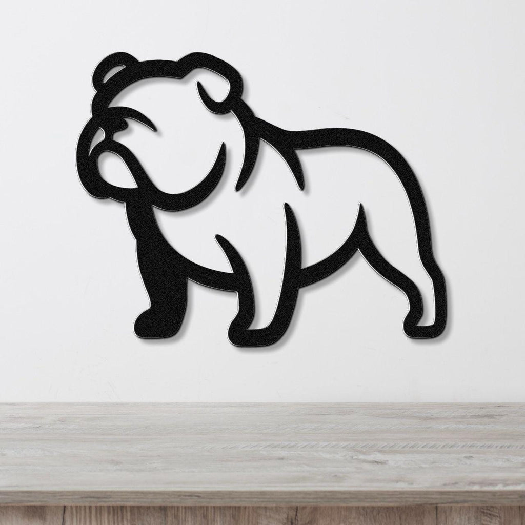 Black metal bulldog wall art with a minimalist silhouette design, mounted on a white wall above a light wood surface.