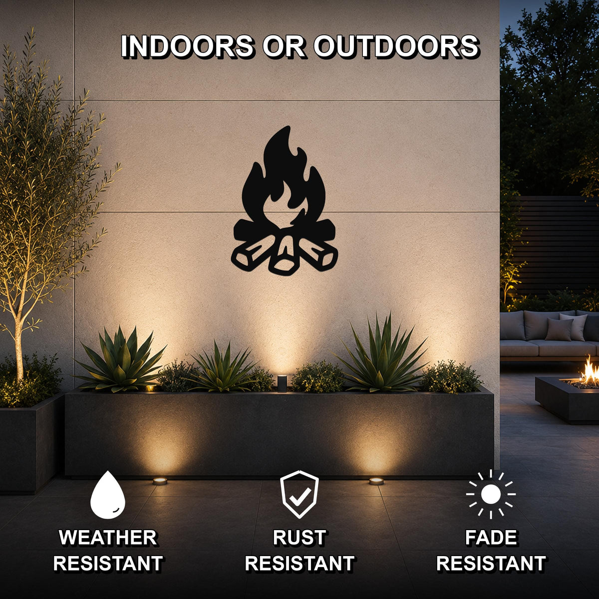 Black metal campfire silhouette wall art mounted on a textured outdoor wall above a planter, with warm uplighting and visible weather, rust, and fade resistance icons.