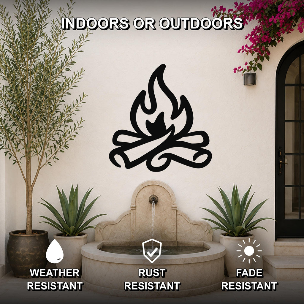 Black metal campfire silhouette wall art mounted on an outdoor patio wall above a stone fountain, surrounded by potted plants and a flowering vine.