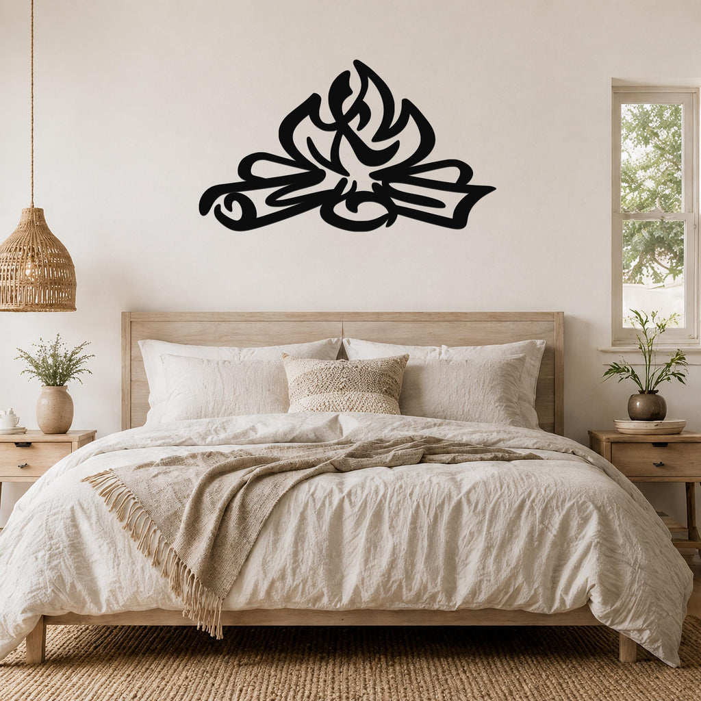 Black metal wall art with a flame silhouette design, mounted above a bed in a rustic bedroom.