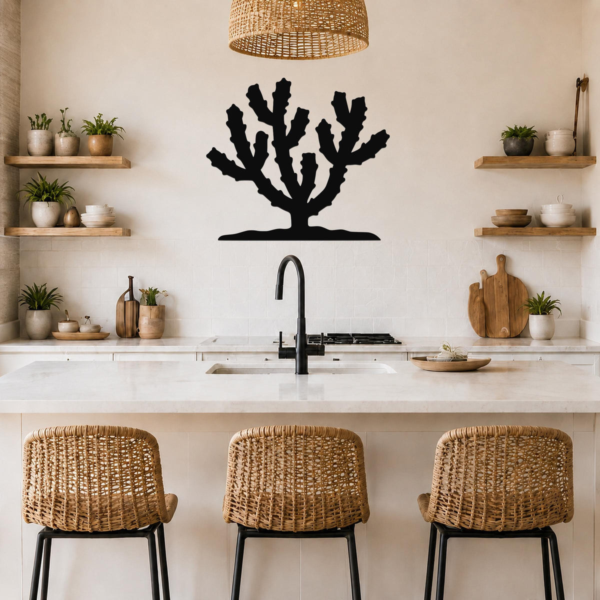 Black metal Cholla cactus wall art silhouette with branching arms, mounted on a kitchen wall above a counter with open shelves and wicker stools.