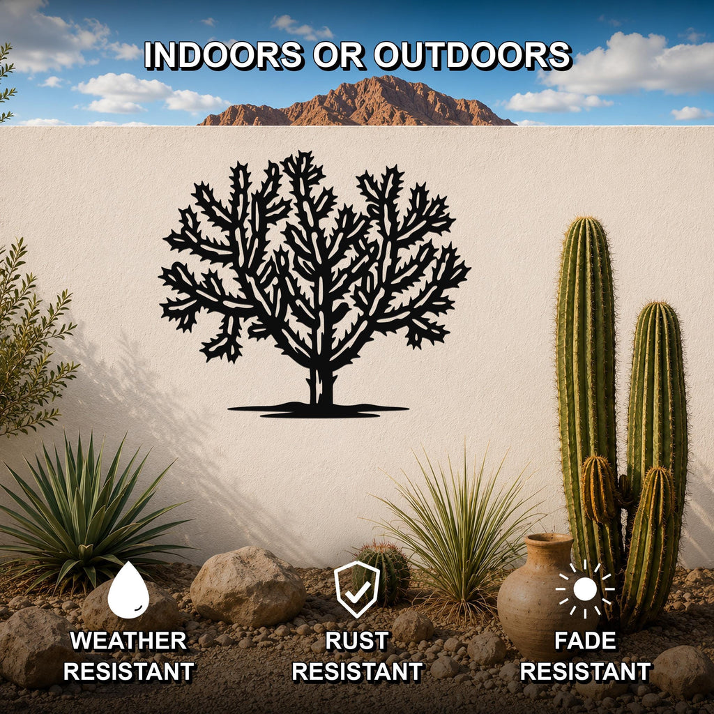 Black metal Cholla cactus wall art with intricate branch cutouts, mounted on an outdoor wall in a desert garden setting.