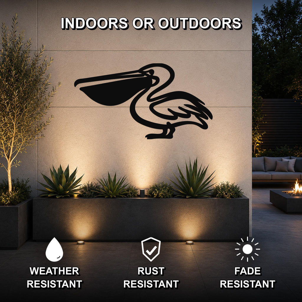Black metal pelican wall art with a cutout silhouette, mounted on an outdoor wall above a planter in a modern patio setting.
