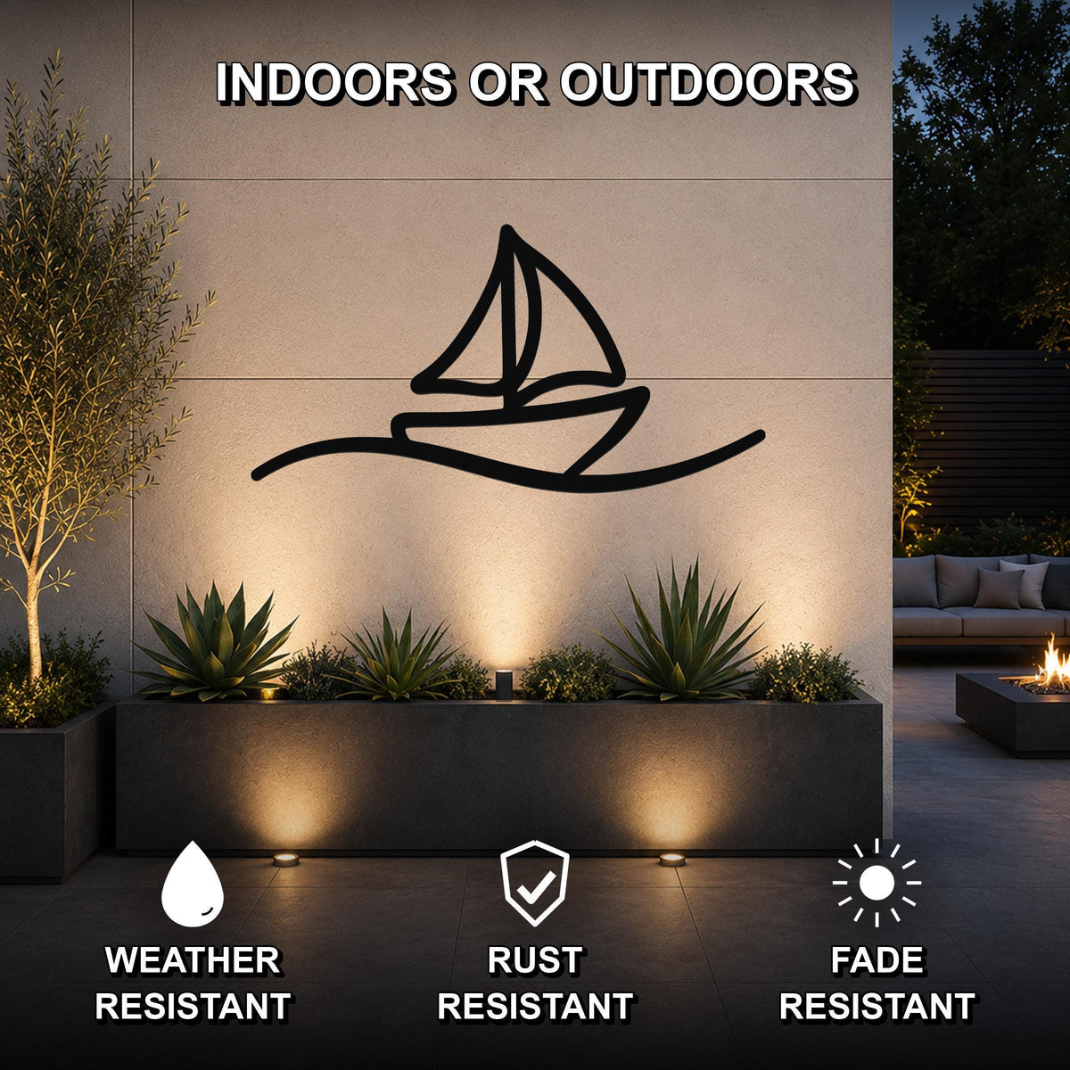 Black metal sailboat wall art with wave cutout, mounted on an outdoor wall above a planter in a patio setting.