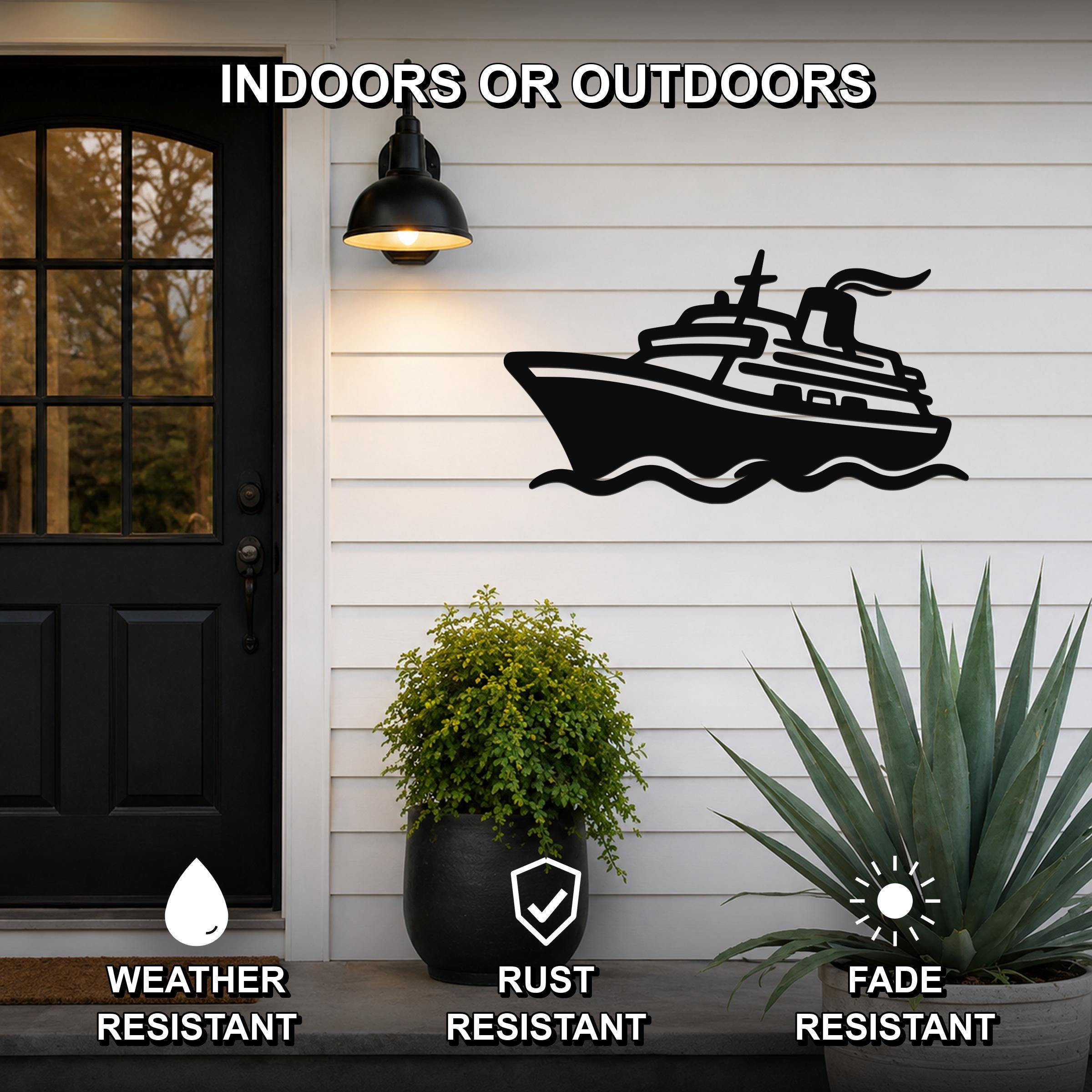 Black metal cruise ship wall art with wave cutouts, mounted on a white siding wall beside a front door, weather resistant, rust resistant, and fade resistant.