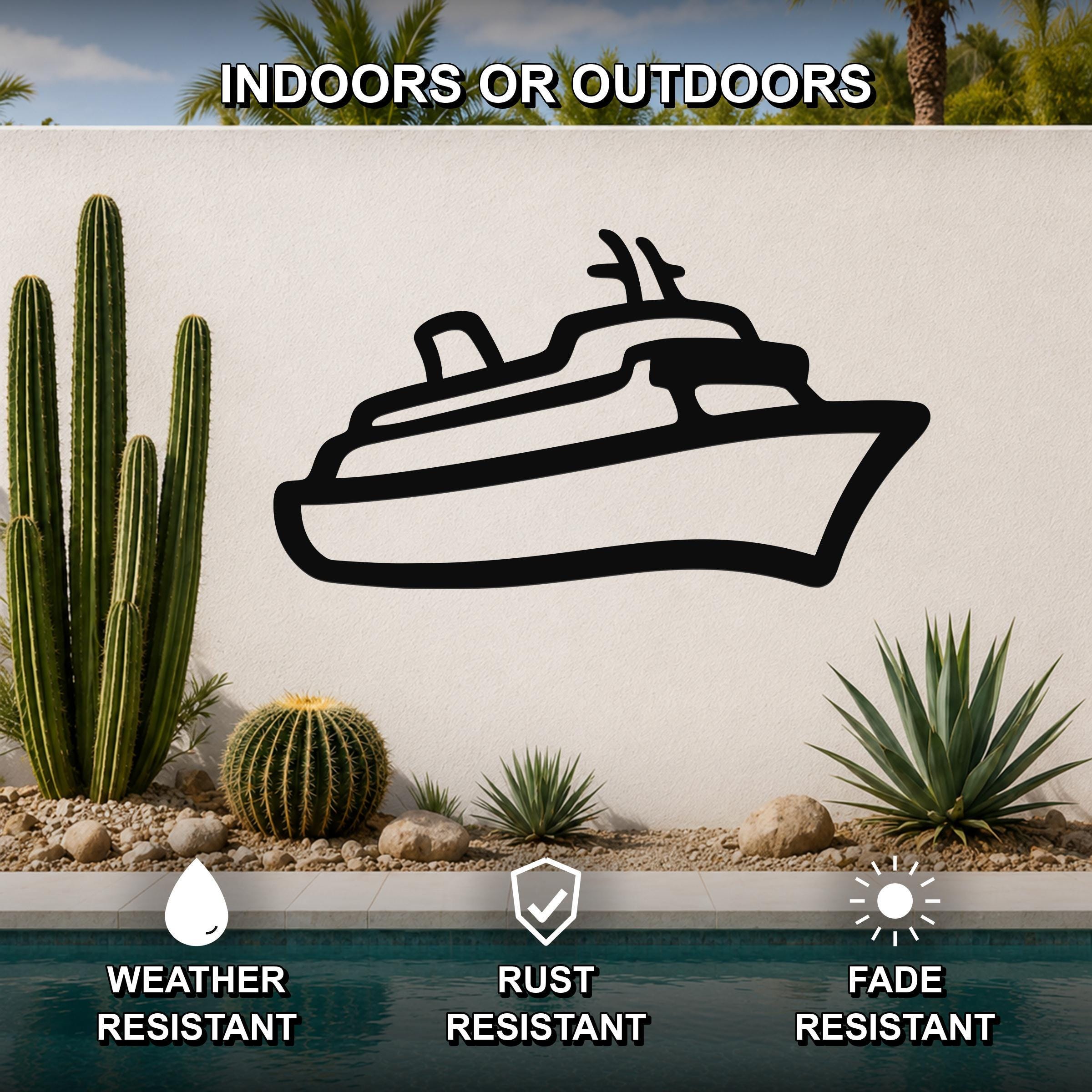 Black metal cruise ship wall art silhouette mounted on an outdoor wall beside a pool, with cacti and palm trees in the background.