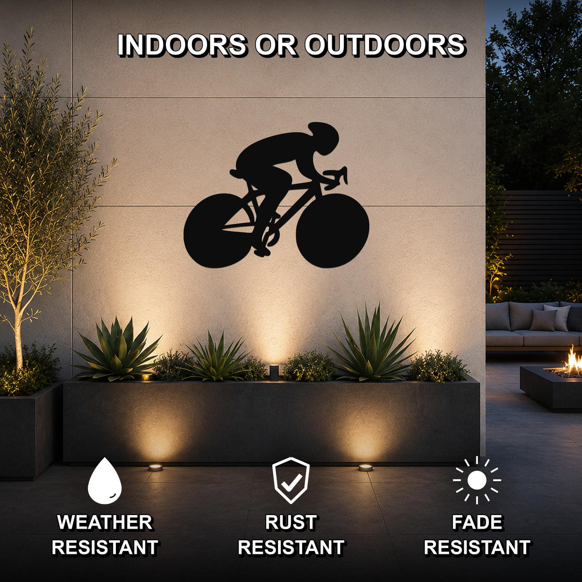 Black metal wall art featuring a bold silhouette of a cyclist on a road bike, mounted on an outdoor wall above a planter with succulents and ambient lighting.