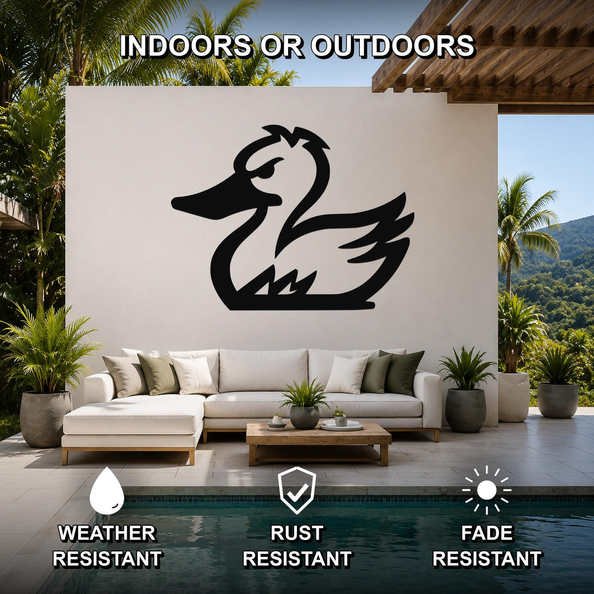 Black metal duck silhouette wall art mounted on a white outdoor wall above a white sectional sofa in a patio living area.