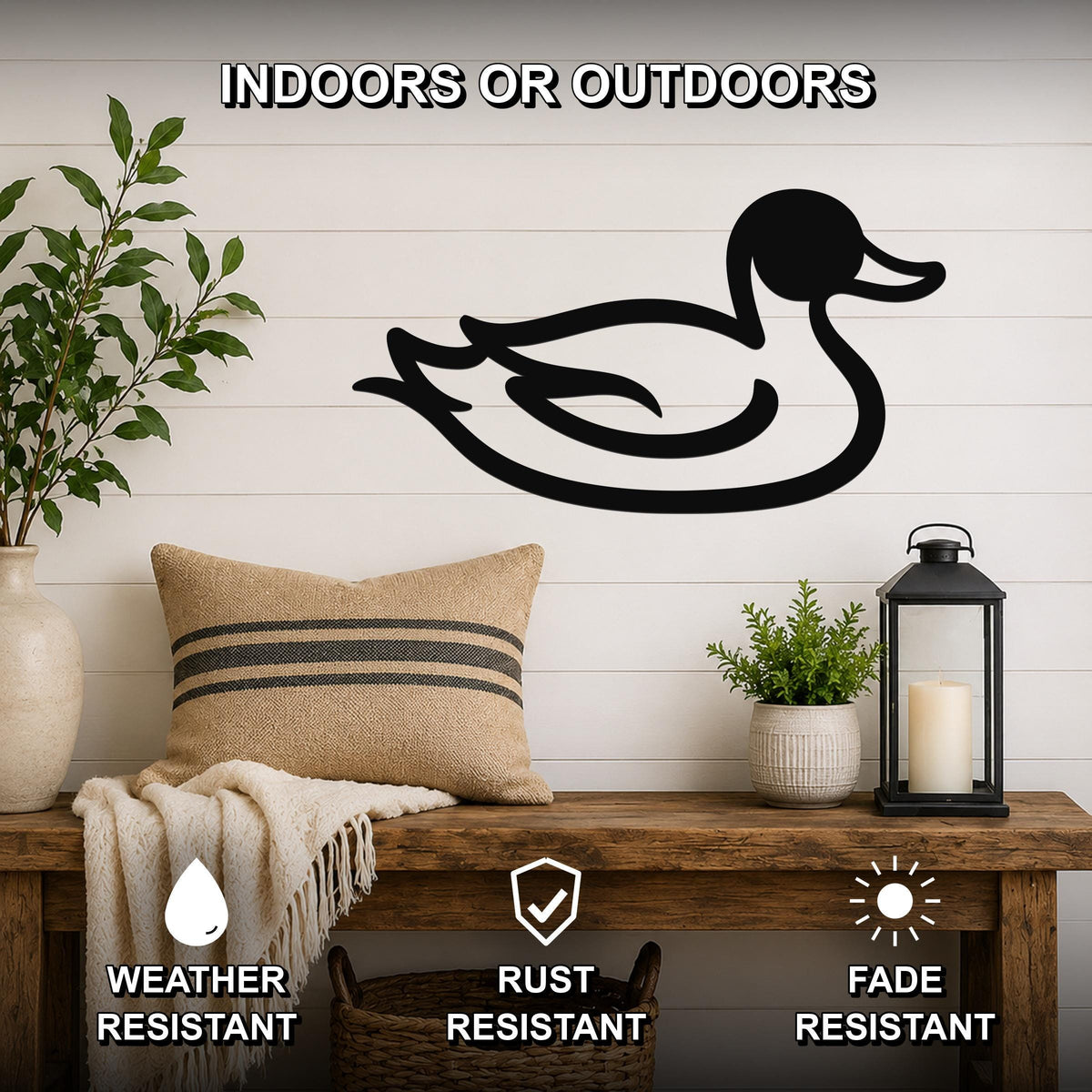 Black metal duck silhouette wall art mounted on a white shiplap wall above a wooden bench in a rustic living room.
