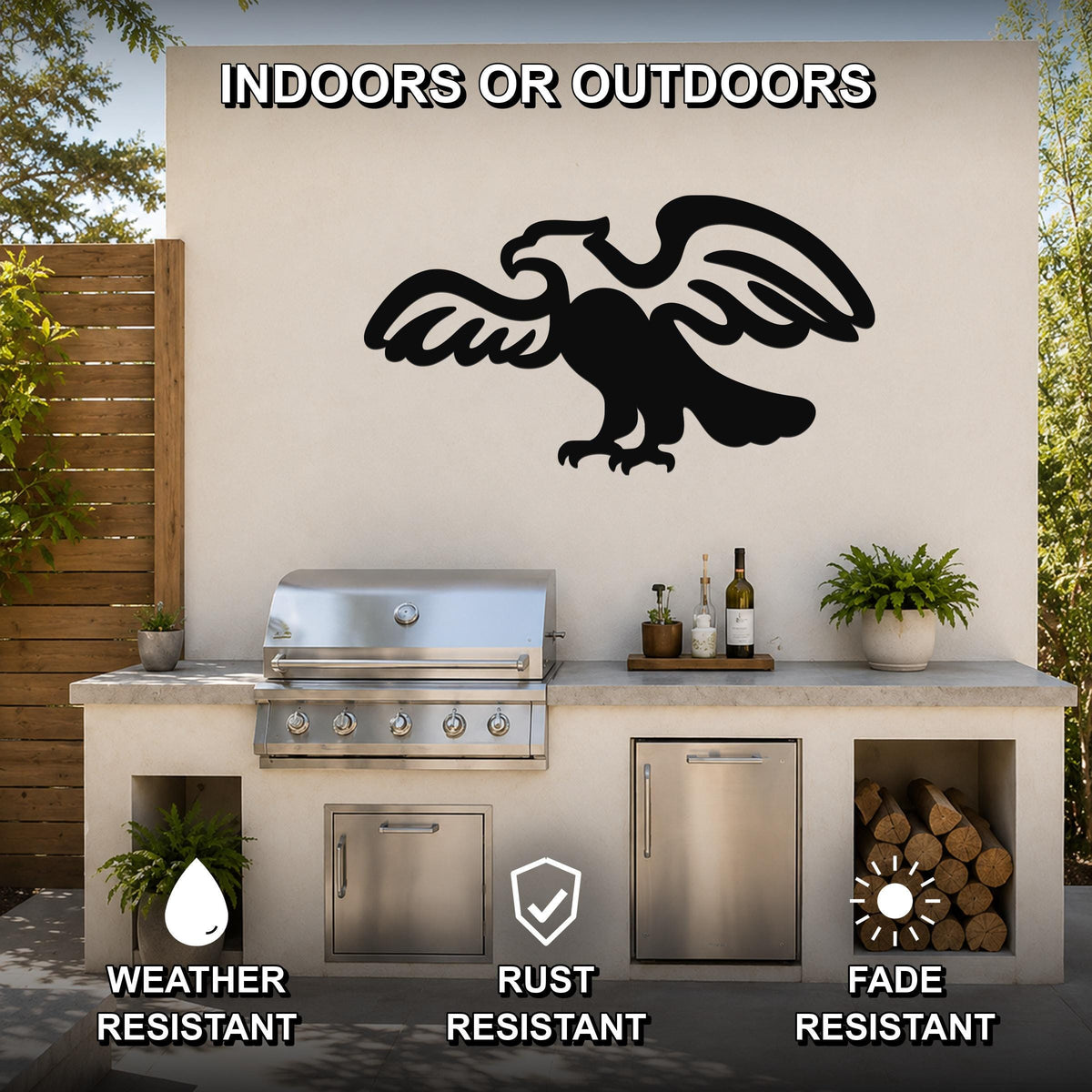 Black metal eagle wall art with outstretched wings and detailed feather cutouts, mounted on an outdoor kitchen wall above a stainless steel grill.