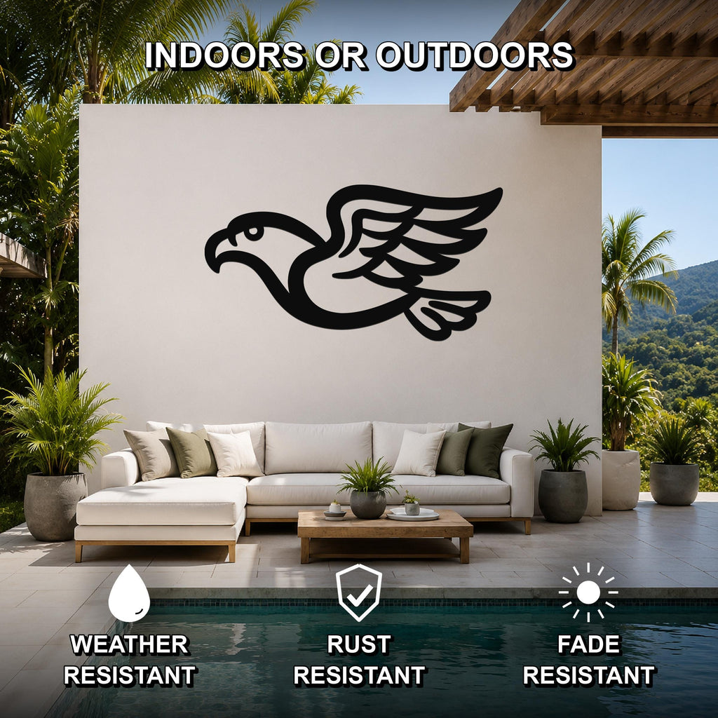 Black metal eagle wall art with a bold silhouette and outstretched wings, mounted on a white outdoor wall above a sofa in a patio living area.