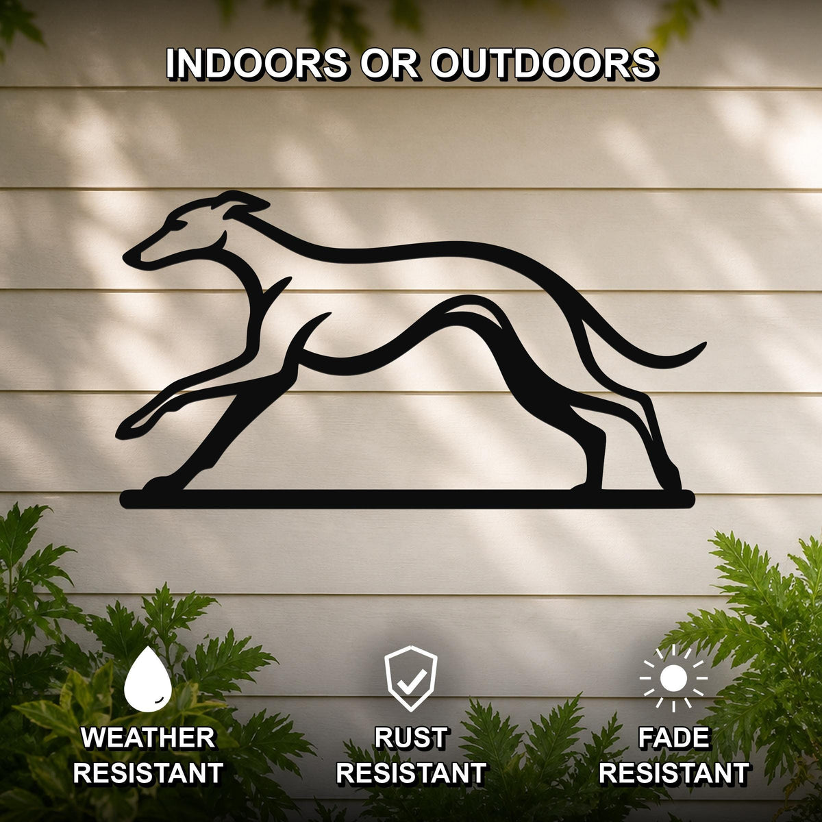 Black metal greyhound wall art silhouette with motion-line cutouts, mounted on a light-colored outdoor wall with greenery below.