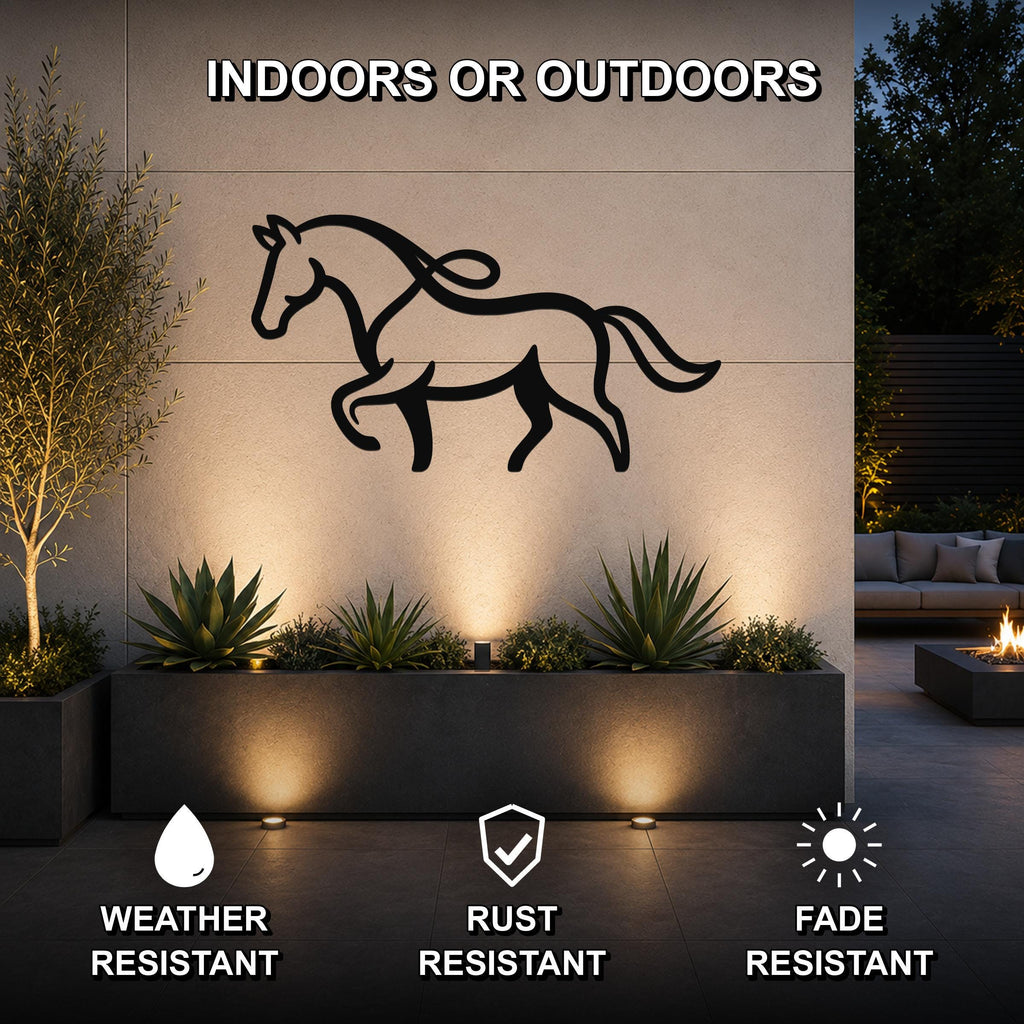 Black metal horse silhouette wall art with flowing mane and tail cutouts, mounted on an outdoor wall above a planter in a modern patio setting.