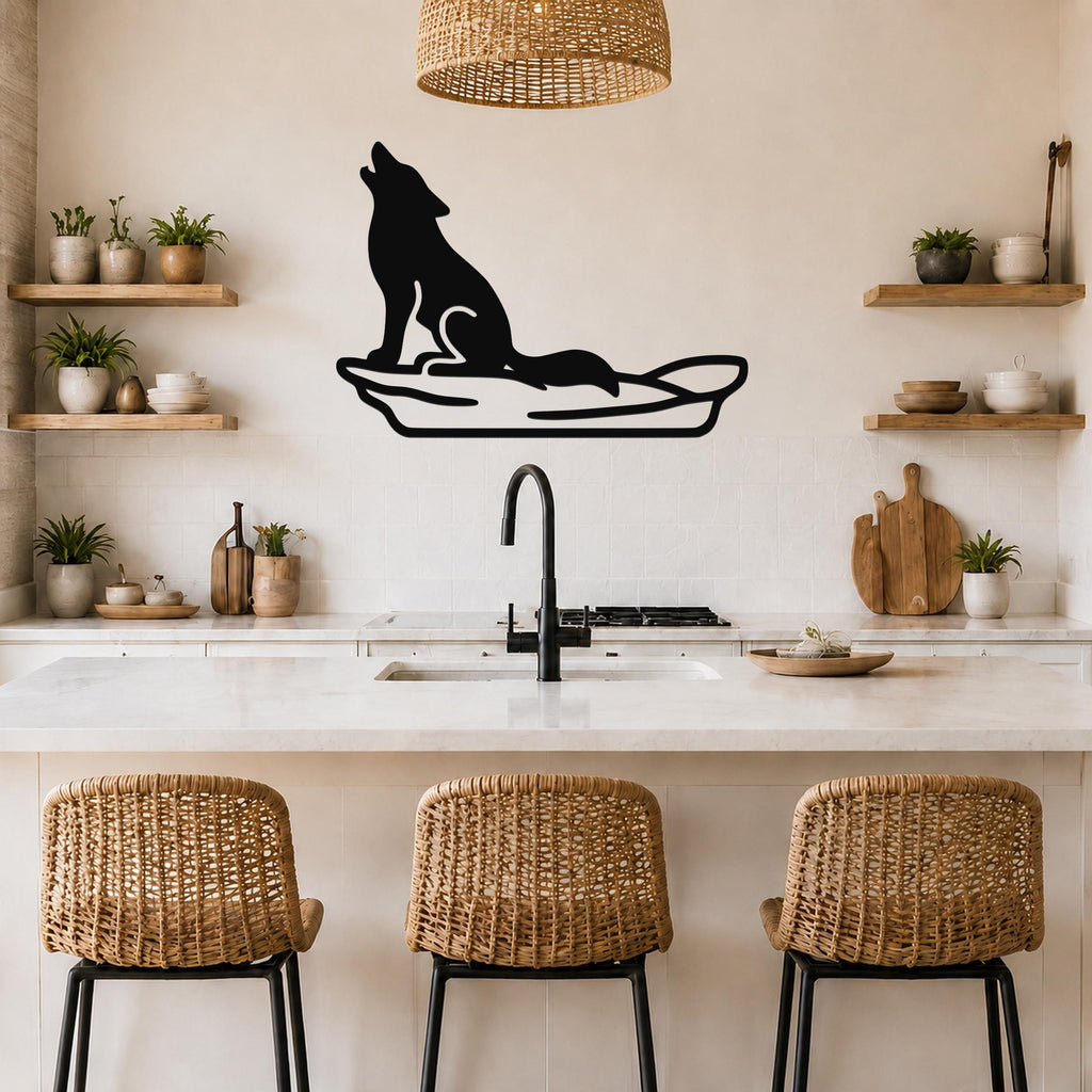 Black metal coyote wall art in a howling silhouette, mounted above a kitchen counter with a sink and wicker bar stools.