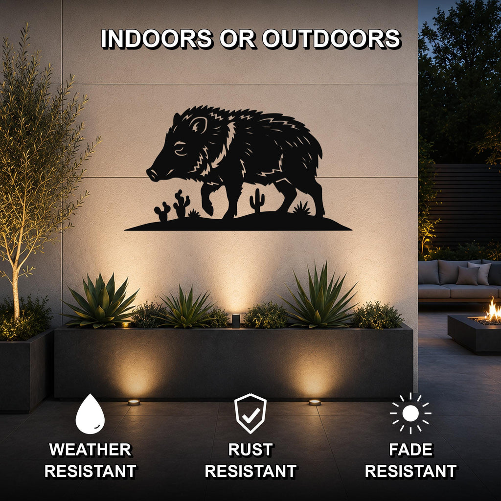 Black metal javelina wall art with cactus cutouts, mounted on an outdoor wall above a planter in a patio setting.