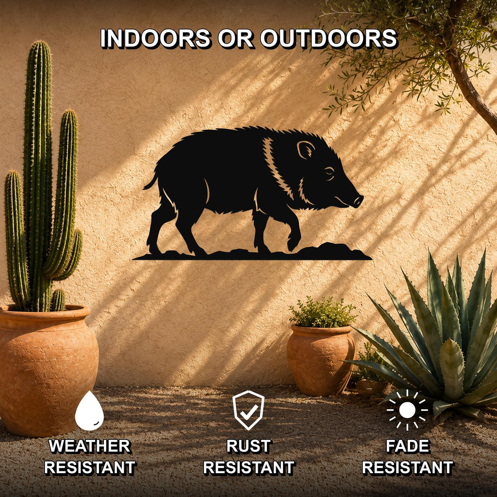 Black metal javelina wall art silhouette mounted on an outdoor stucco wall, surrounded by potted cacti and succulents in a desert-style patio setting.