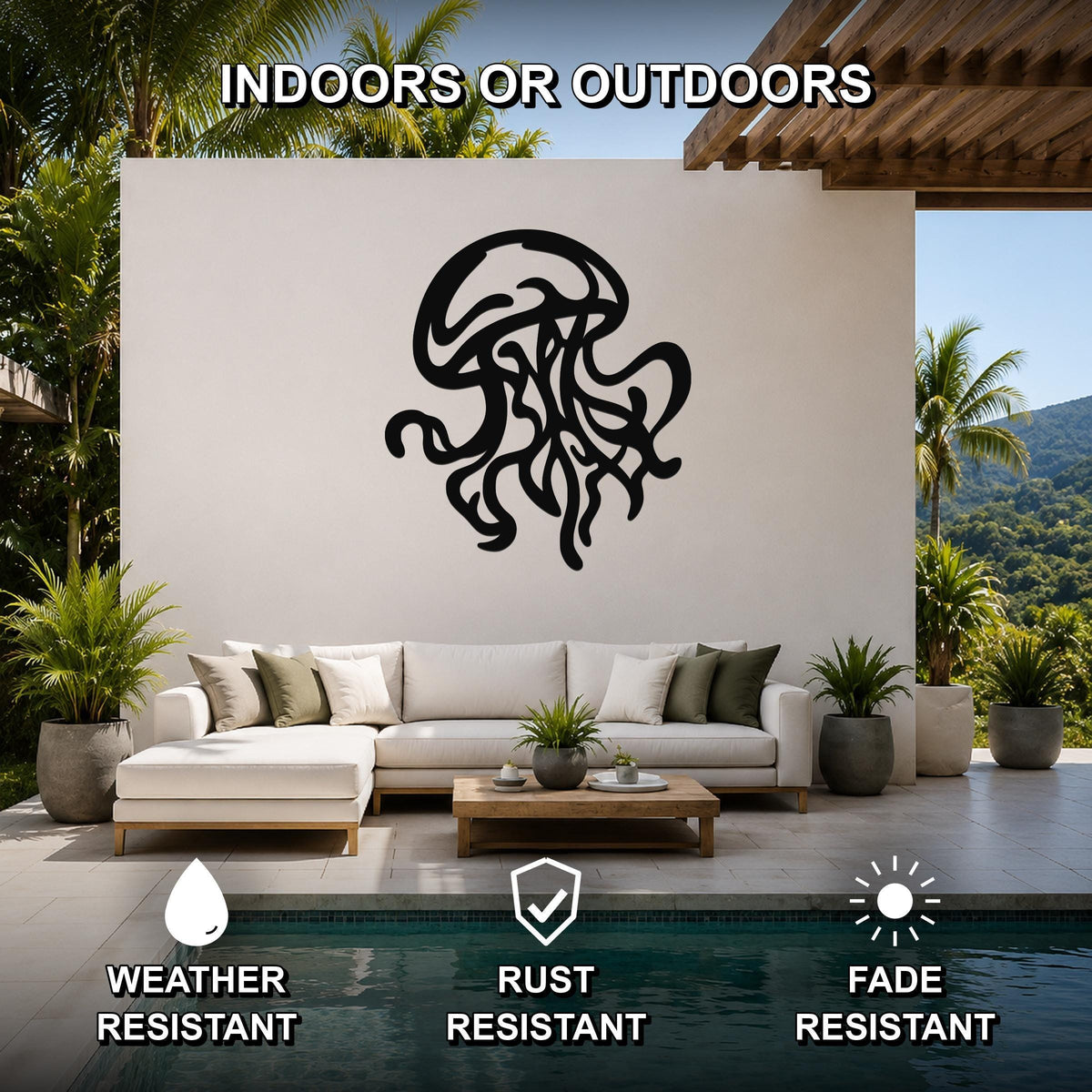 Black metal jellyfish wall art with tentacle cutouts, mounted on a white outdoor wall above a sofa in a patio living area.