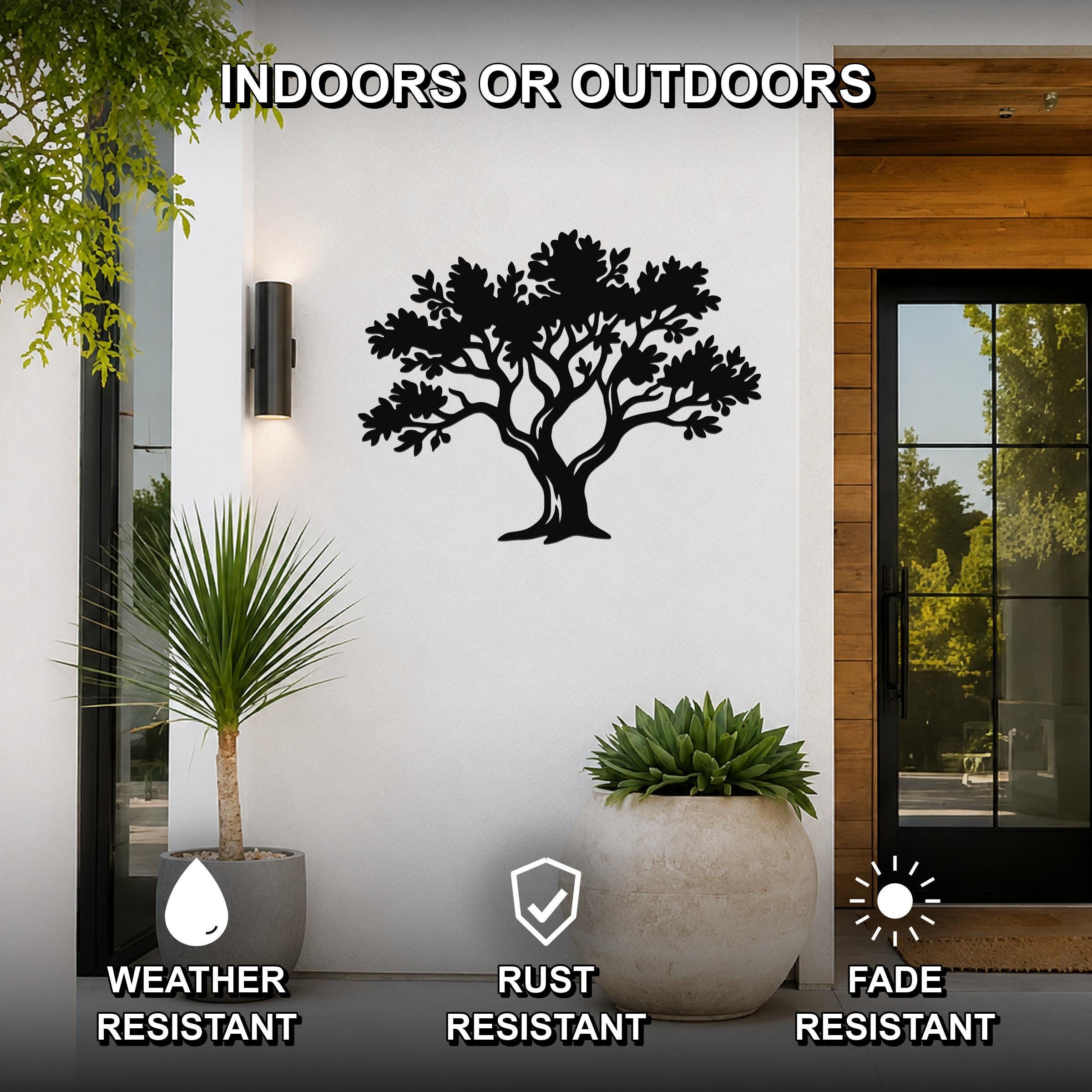 Black metal tree wall art with detailed branch and leaf cutouts, mounted on a white exterior wall beside a glass door and potted plants, labeled as weather, rust, and fade resistant for indoor or outdoor use.