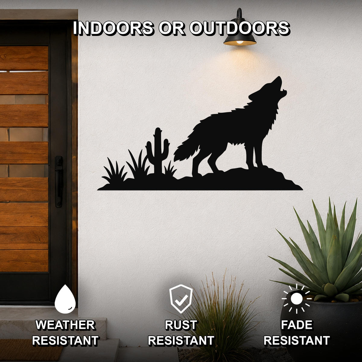 Black metal wall art featuring a coyote howling silhouette with cactus and desert plants, mounted on an outdoor wall beside a door, weather, rust, and fade resistant.