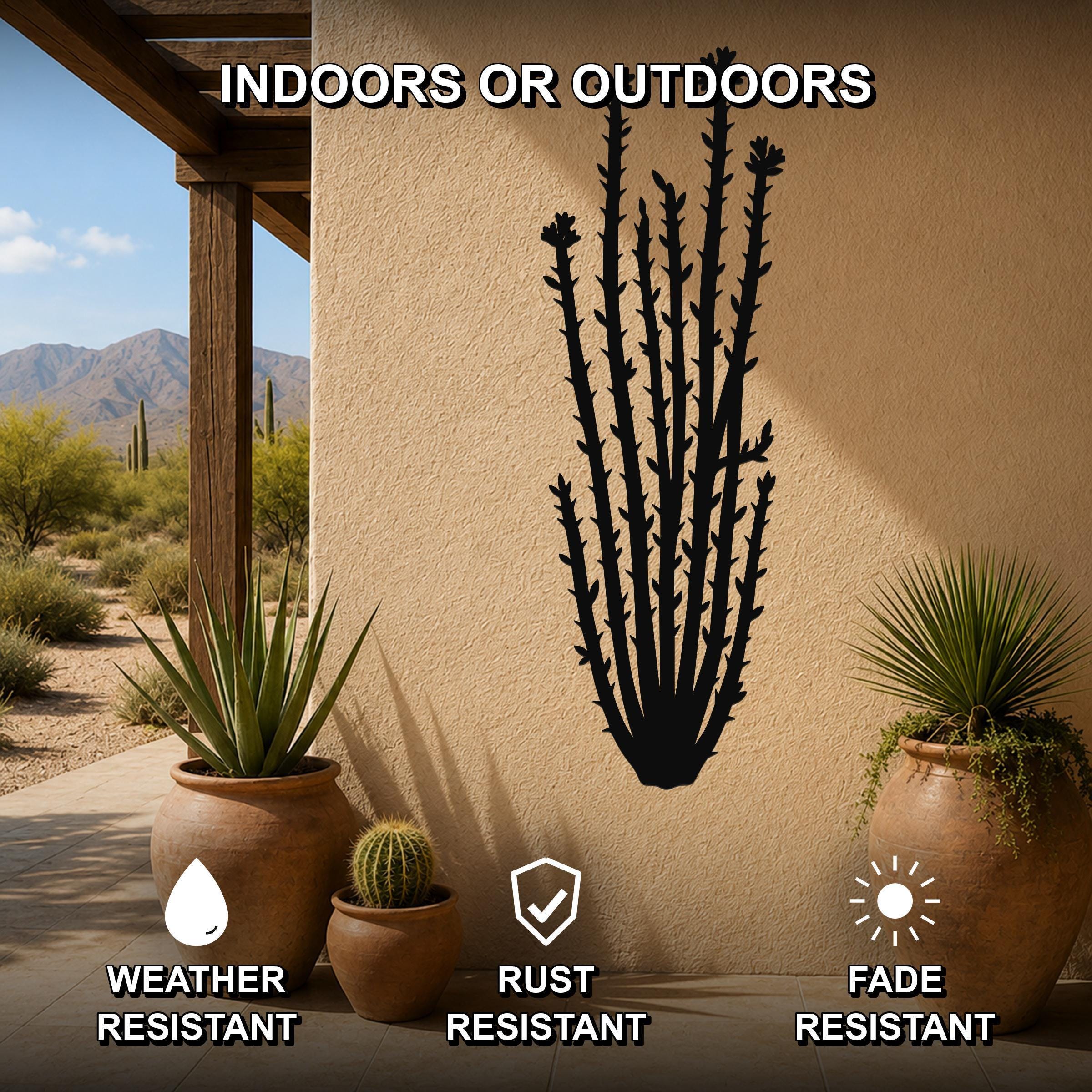 Black metal ocotillo wall art with spiny branch cutouts, mounted on an outdoor patio wall above potted plants.