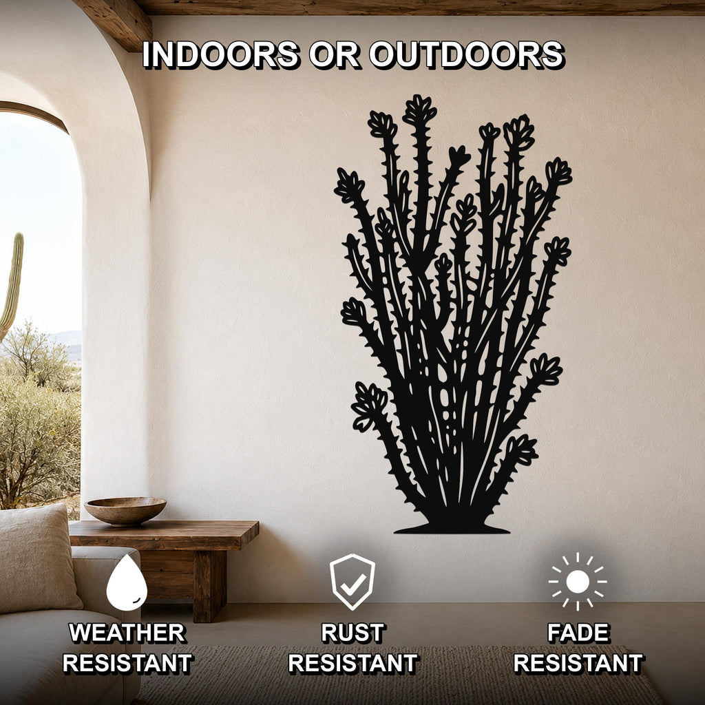 Black metal ocotillo wall art with detailed spines and flower cutouts, mounted on a beige wall in a living room with an arched doorway and wooden furniture.